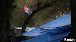 La bandera cubana ondea en una tienda de campaña, en un campamento de inmigrantes en Matamoros, México, el 18 de febrero de 2021. REUTERS/Daniel Becerril